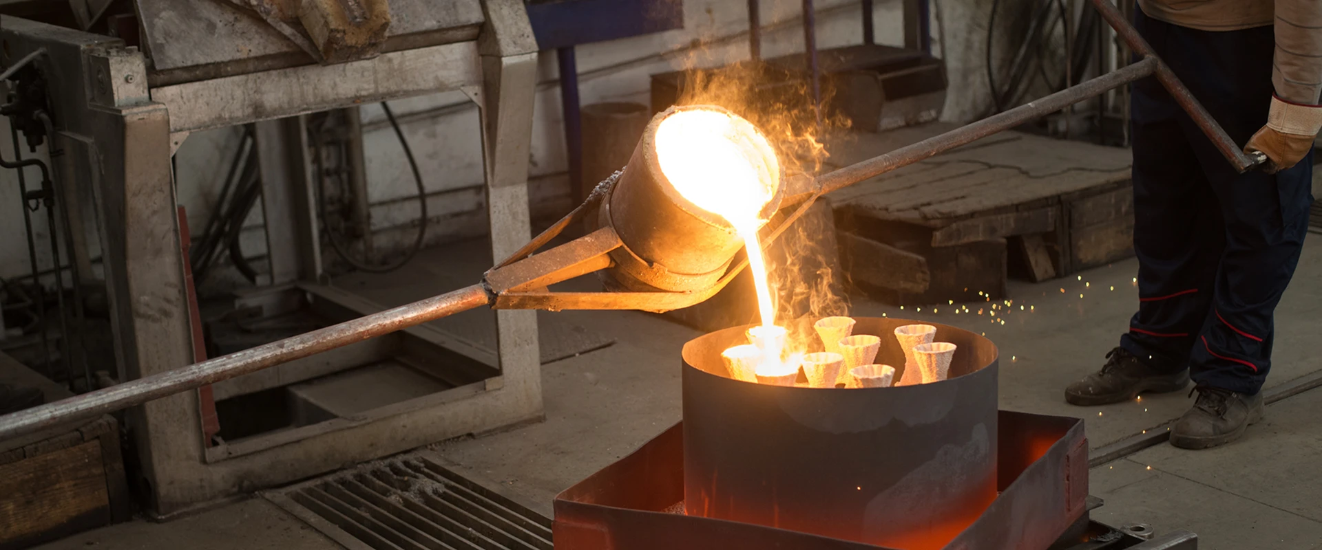 Pouring molten metal into casting molds.